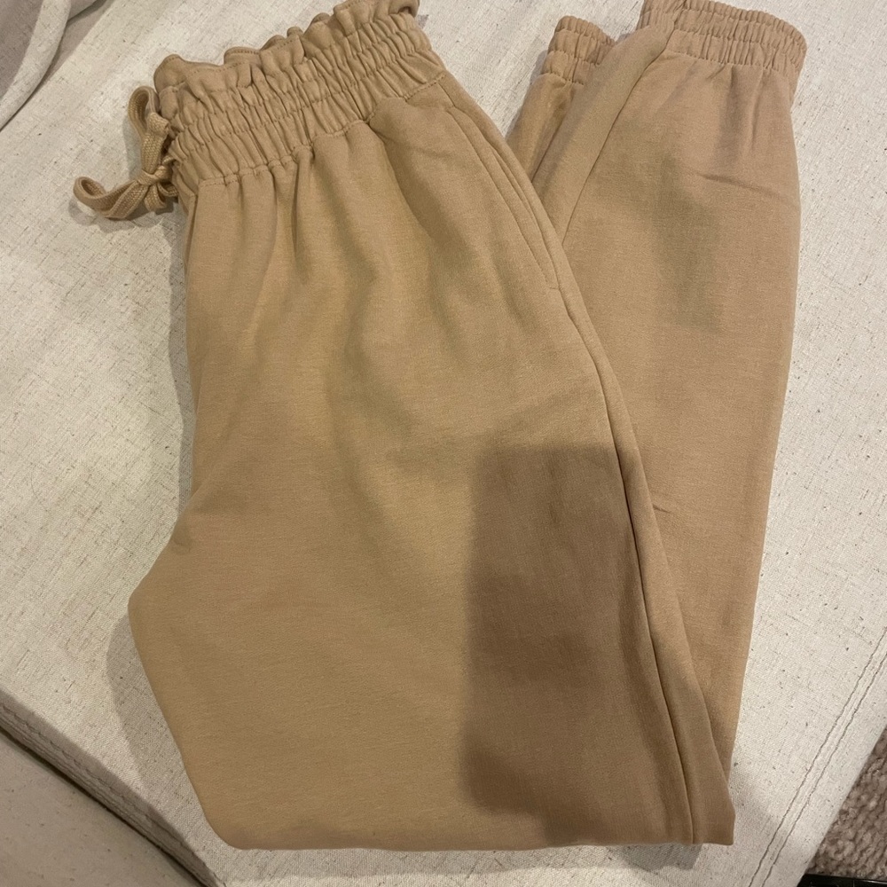 Size small tan joggers. Stretchy cotton like material with stretchy waistband